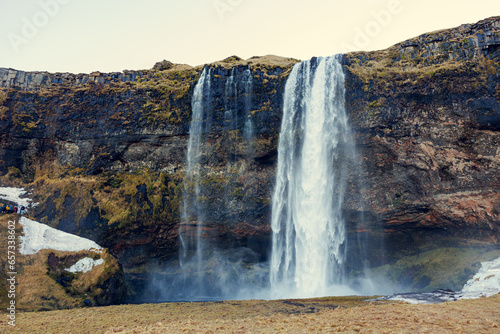 Majestic cascade in icelandic scenery with river falling off cliffs and mountains  seljalandsfoss waterfall with stream. Outstanding nordic nature with spectacular massive water flow.