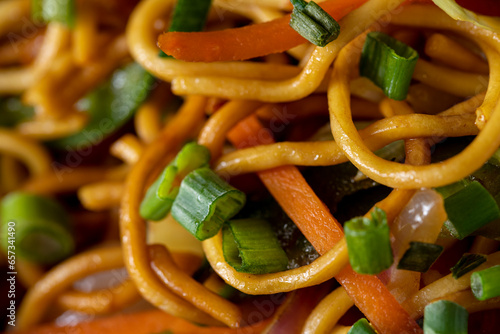 Close up of noodles, green onions, carrots