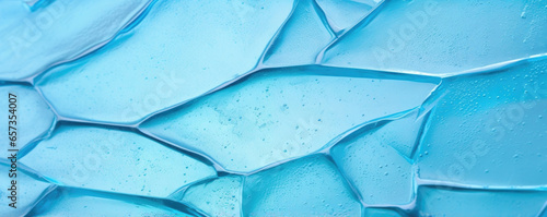Closeup of a crackled fused glass piece, showing a mix of jagged and smooth edges with a frosted, textured surface.