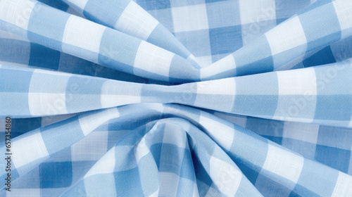 Closeup of a blue and white gingham plaid fabric, reminiscent of a picnic blanket. The texture is lightweight and loosely woven, perfect for summery dresses or lightweight curtains.