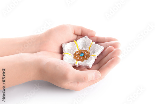 Female hands with beautiful diya lamp for celebration of Divaly on white background, closeup