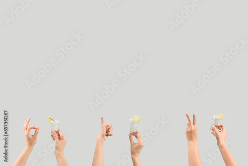 Female hands holding shots ...
