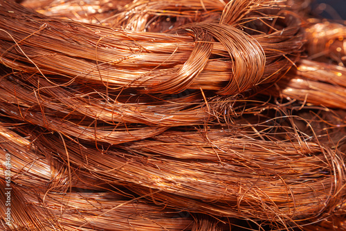 Scrap copper stripped cables twisted and collected in a heap, close-up.