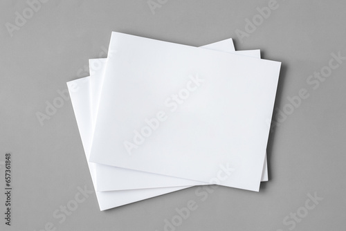 White booklets isolated on grey background. 3D render