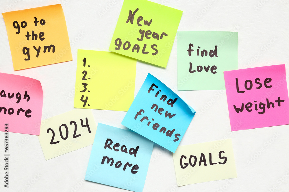 Sticky notes with different goals for 2024 on white background