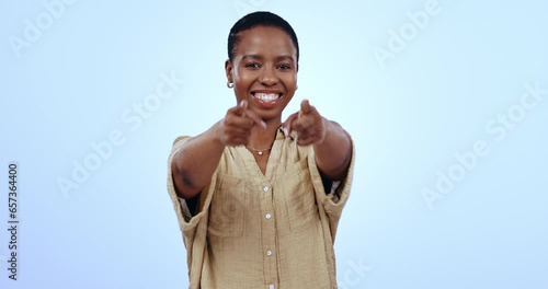 Face, pointing to you and black woman with promotion, accountability and opportunity on a blue studio background. Portrait, African person or model with hand gesture, support and winnig with feedback photo