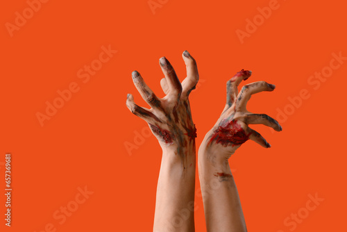 Zombie hands on orange background. Halloween celebration