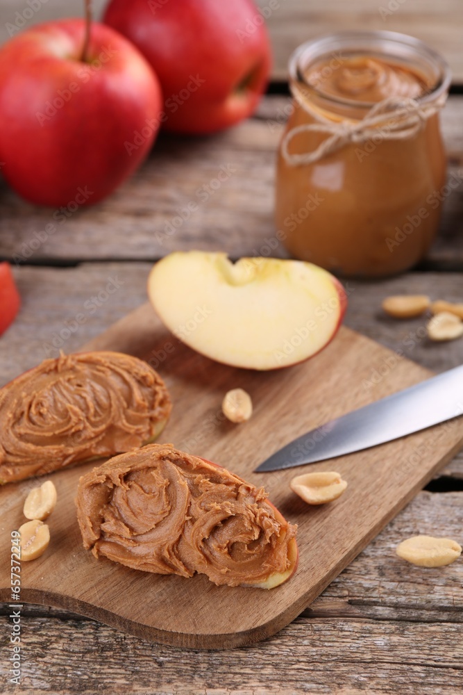 Fresh apples with peanut butter on wooden table Fresh apples with peanut butter on wooden table
