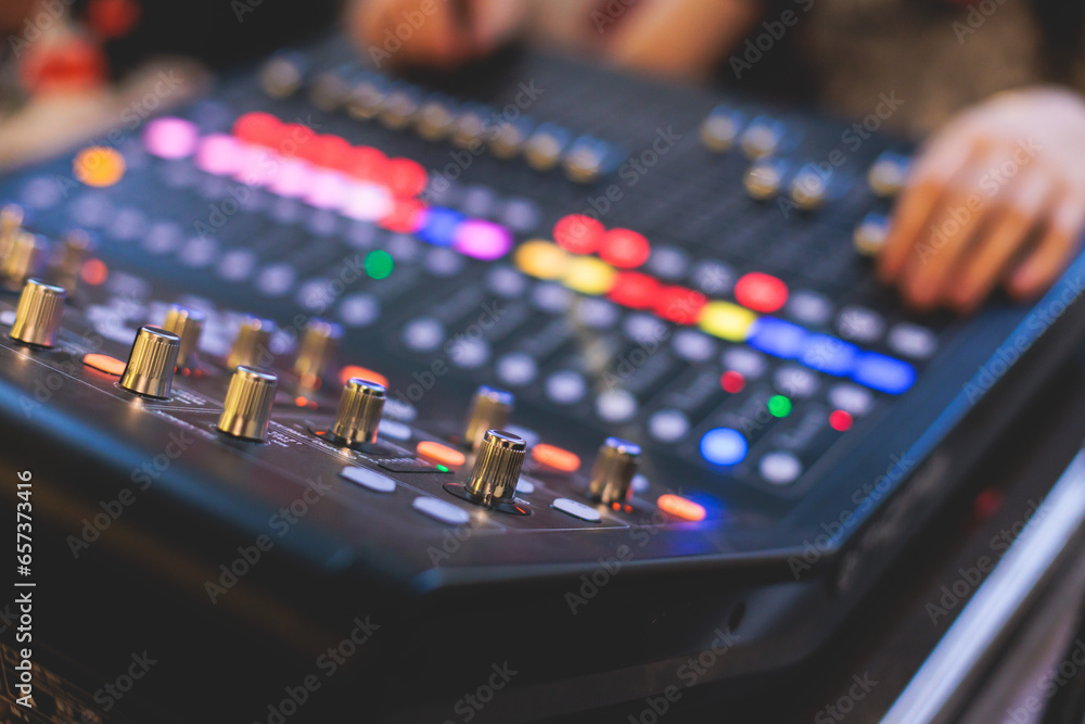 View of lighting technician operator working on mixing console workplace during live event concert on stage show broadcast, light mixer controller panel, sound technician with professional equipment - obrazy, fototapety, plakaty 