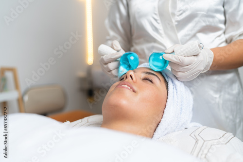 Woman receiving a massage with cold spheres in a spa