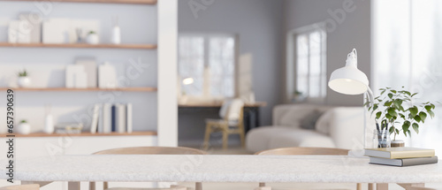 A copy space on a tabletop over a blurred minimal white living room in the background.