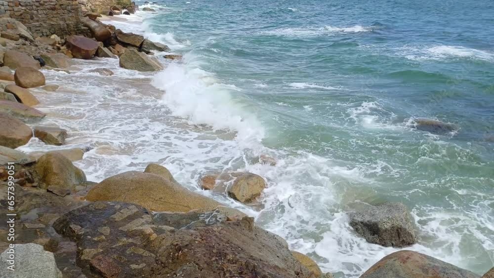 Ocean waves foam and splash a on the rocks of Ca Na beach, Ninh Thuan, Vietnam. Ocean waves foam and splash a on the rocks of Ca Na beach, Ninh Thuan, Vietnam.