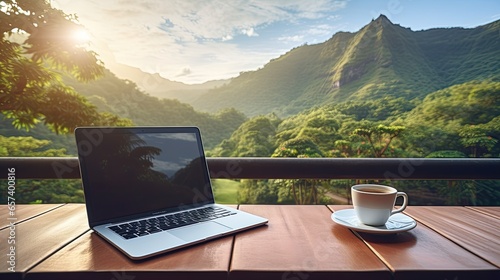 Workspace with laptop and coffee on wooden table with nature mountain background, Freelance worker. photo