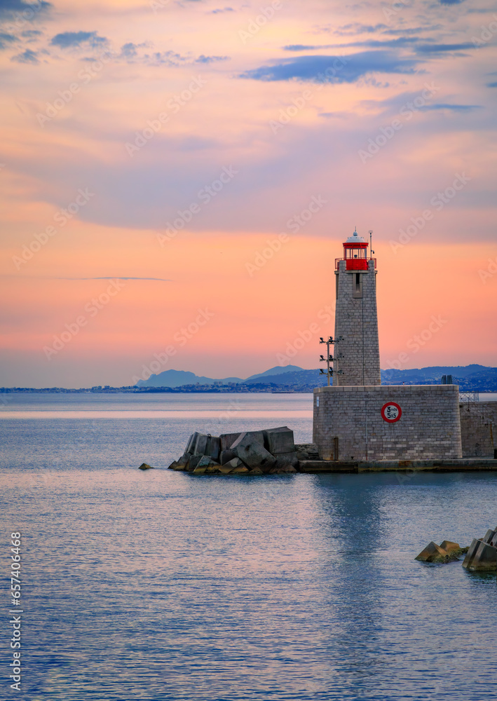 Stunning view of the Mediterranean Sea with the lighthouse in the harbor at sunset in Nice, South of France or the French Riviera