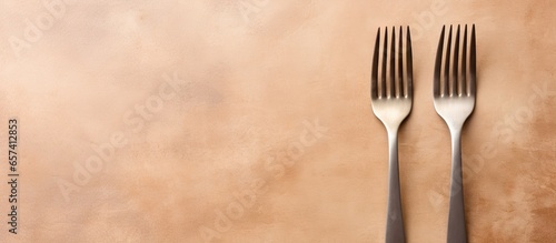 Three forks made of stainless steel photographed on a isolated pastel background Copy space