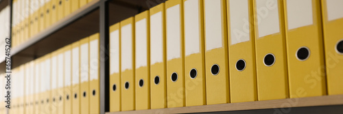 Yellow folders with materials put in long rows on shelves