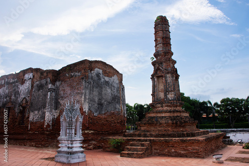 Ancient ruins ubosot ordination hall and antique old ruin stupa chedi for thai people visit respect praying blessing at Wat Yai Chom Prasat temple in Tha Chin at Tha Chalom in Samut Sakhon, Thailand photo