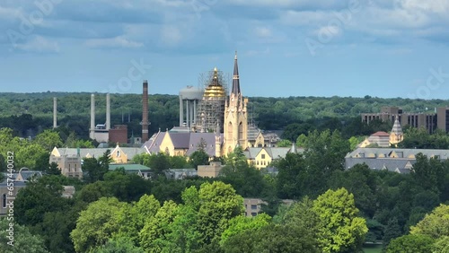 Basilica of the Sacred Heart steeple, Washington Hall, and Undergraduate Admissions main building at University of Notre Dame. Aerial establishing shot on summer day with zoom lens. photo