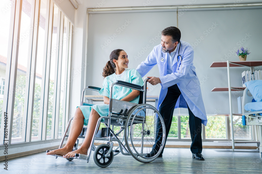 Doctor taking care and talking mature female patient sitting on wheelchair in hospital. Healthcare concept, Banner cover design. Doctor taking care and talking mature female patient sitting on wheelchair in hospital. Healthcare concept, Banner cover design.
