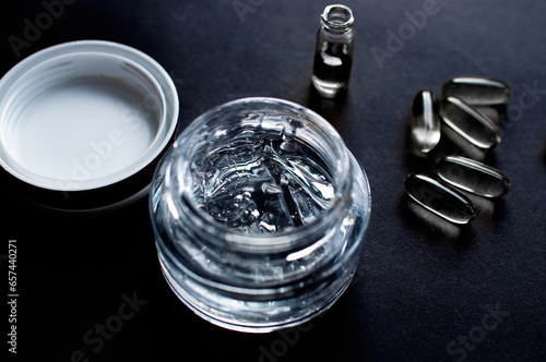Close up of glass jar with cosmetic oil and serum