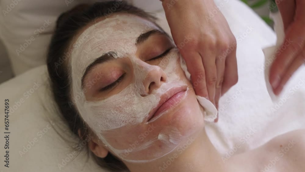 Beautician hands washing patient face with wet wipes. Cleansing before Cosmetology procedure. Facial skincare Beautician hands washing patient face with wet wipes. Cleansing before Cosmetology procedure. Facial skincare