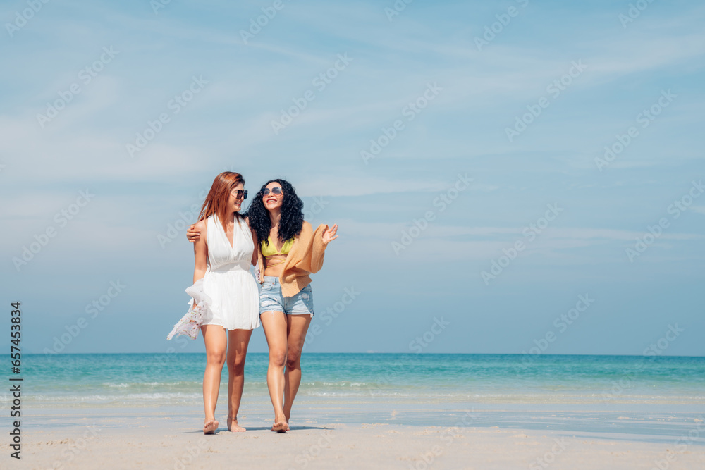 Happy couple woman in bikini walking and playing together on the beach having fun in a sunny day, Beach summer holiday sea people concept. Happy couple woman in bikini walking and playing together on the beach having fun in a sunny day, Beach summer holiday sea people concept.