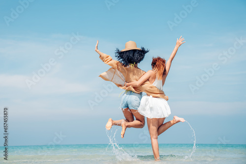Sticker Happy couple woman in bikini walking and playing together on the beach having fun in a sunny day, Beach summer holiday sea people concept
