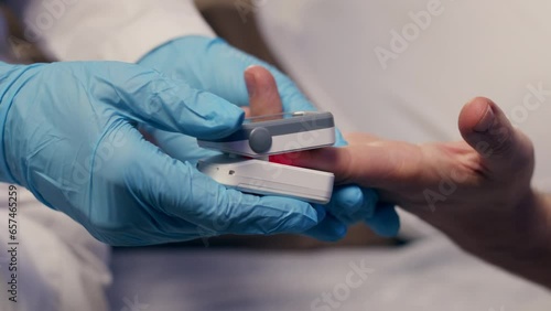 Pulse oximeter on a white background. Infrared isometric thermometer to check body temperature for virus symptoms. Measures oxygen saturation, heart rate and oxygen levels. photo