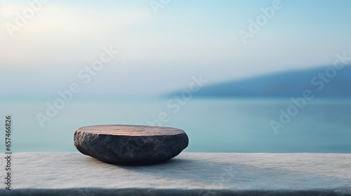 A mockup product display background featuring a stunning ocean backdrop. The product mockup is set on a dark, flat stone podium. photo