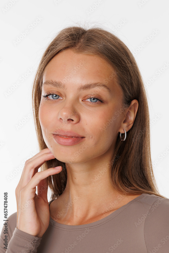 Beautiful young girl with fresh healthy skin. Woman advertise ear-rings. White background. Earrings, ear caffs closeup. Blond european woman with long hair with big lips, pretty smile. Cosmetology Beautiful young girl with fresh healthy skin. Woman advertise ear-rings. White background. Earrings, ear caffs closeup. Blond european woman with long hair with big lips, pretty smile. Cosmetology