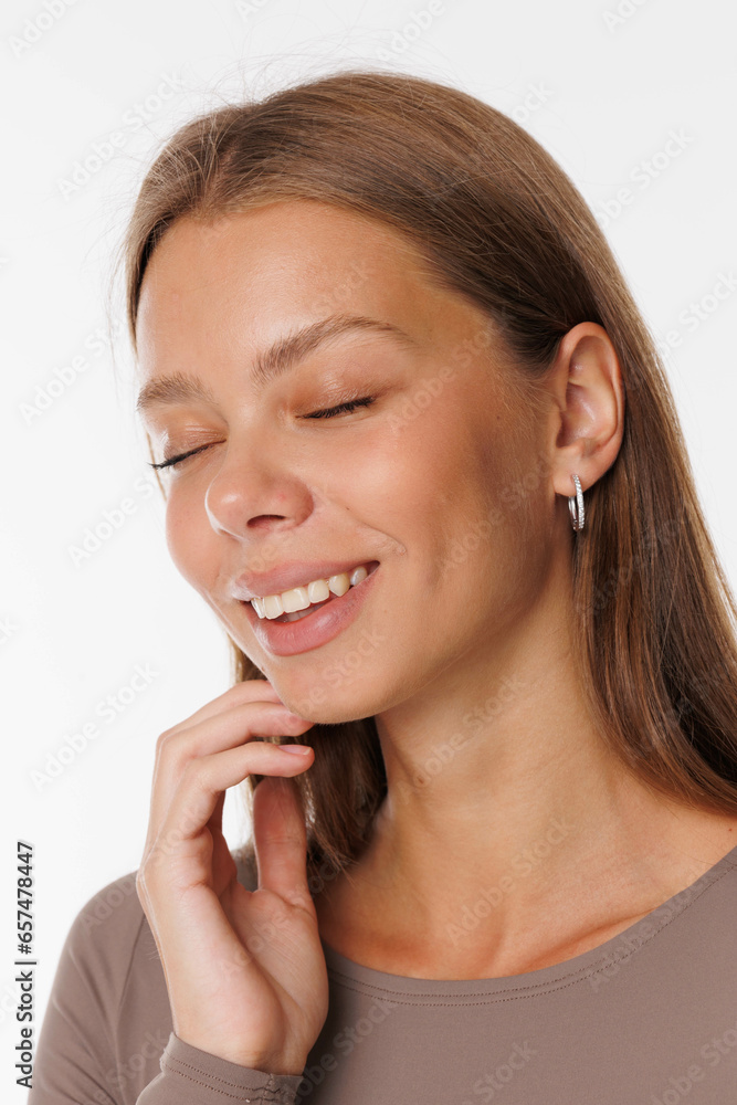 Beautiful young girl with fresh healthy skin. Woman advertise ear-rings. White background. Earrings, ear caffs closeup. Blond european woman with long hair with big lips, pretty smile. Cosmetology Beautiful young girl with fresh healthy skin. Woman advertise ear-rings. White background. Earrings, ear caffs closeup. Blond european woman with long hair with big lips, pretty smile. Cosmetology