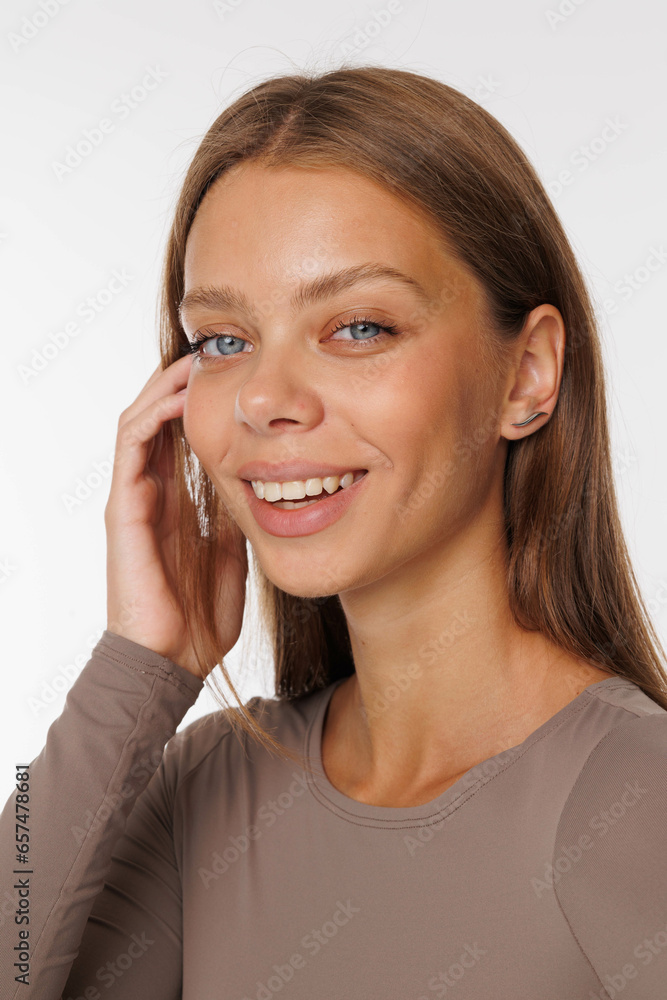 Beautiful young girl with fresh healthy skin. Woman advertise ear-rings. White background. Earrings, ear caffs closeup. Blond european woman with long hair with big lips, pretty smile. Cosmetology Beautiful young girl with fresh healthy skin. Woman advertise ear-rings. White background. Earrings, ear caffs closeup. Blond european woman with long hair with big lips, pretty smile. Cosmetology