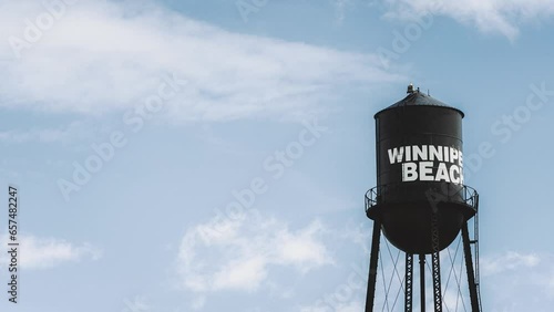 A Zooming Shot of Winnipeg Falcon Beach Black and White Painted Vintage Metal Water Tower Travel Tourist Destination Against a Blue Summer Sky in Gimli Manitoba Canada photo