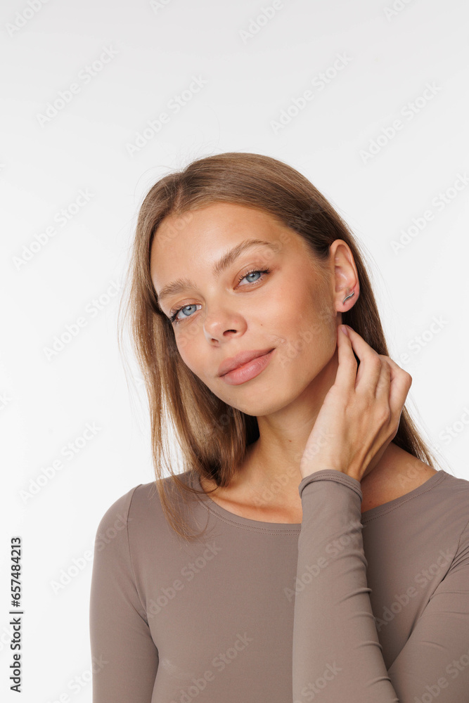 Beautiful young girl with fresh healthy skin. Woman advertise ear-rings. White background. Earrings, ear caffs closeup. Blond european woman with long hair with big lips, pretty smile. Cosmetology Beautiful young girl with fresh healthy skin. Woman advertise ear-rings. White background. Earrings, ear caffs closeup. Blond european woman with long hair with big lips, pretty smile. Cosmetology