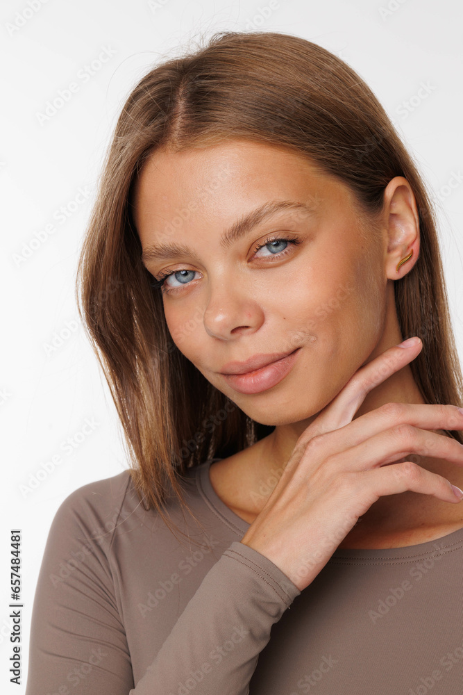 Beautiful young girl with fresh healthy skin. Woman advertise ear-rings. White background. Earrings, ear caffs closeup. Blond european woman with long hair with big lips, pretty smile. Cosmetology Beautiful young girl with fresh healthy skin. Woman advertise ear-rings. White background. Earrings, ear caffs closeup. Blond european woman with long hair with big lips, pretty smile. Cosmetology