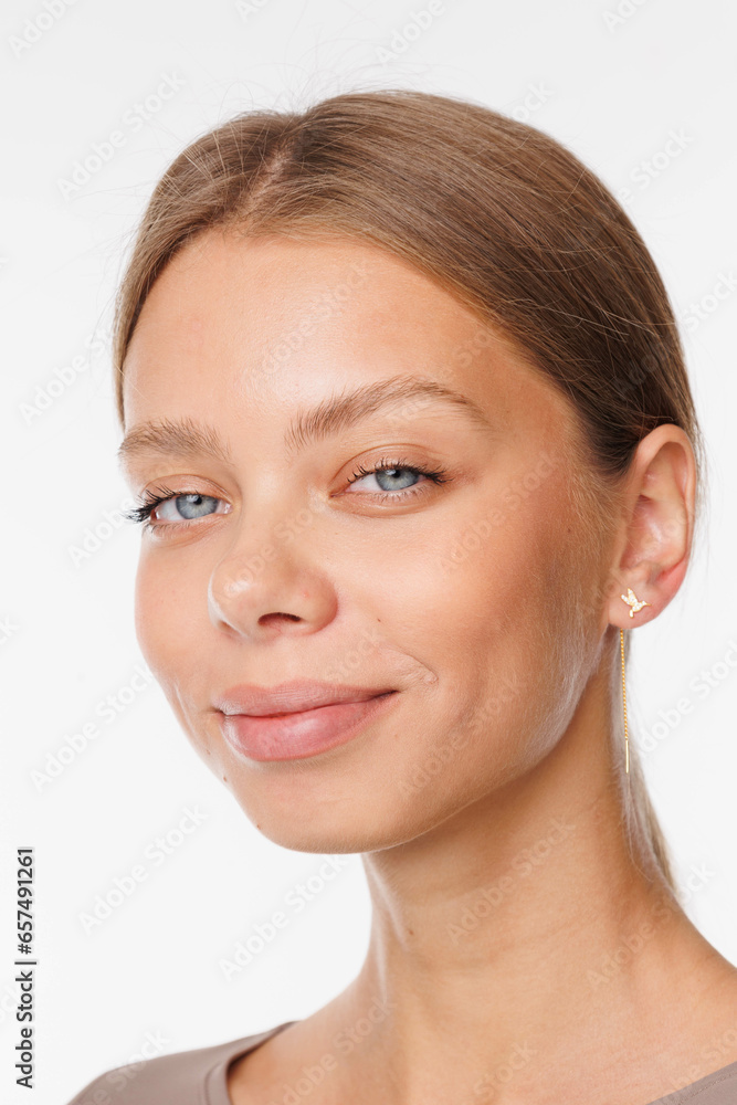 Beautiful young girl with fresh healthy skin. Woman advertise ear-rings. White background. Earrings, ear caffs closeup. Blond european woman with long hair with big lips, pretty smile. Cosmetology Beautiful young girl with fresh healthy skin. Woman advertise ear-rings. White background. Earrings, ear caffs closeup. Blond european woman with long hair with big lips, pretty smile. Cosmetology