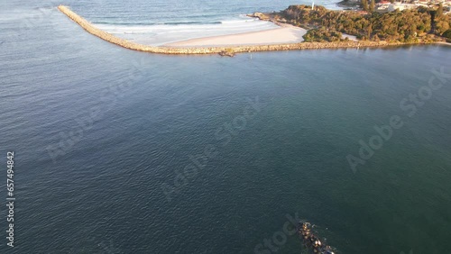 Tilt-up Reveal Of South Break Wall And Turners Beach At The Mouth Of Clarence River In Yamba, NSW, Australia. aerial photo