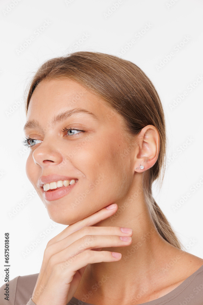 Beautiful young girl with fresh healthy skin. Woman advertise ear-rings. White background. Earrings, ear caffs closeup. Blond european woman with long hair with big lips, pretty smile. Cosmetology Beautiful young girl with fresh healthy skin. Woman advertise ear-rings. White background. Earrings, ear caffs closeup. Blond european woman with long hair with big lips, pretty smile. Cosmetology