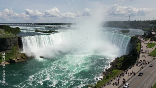 Aerial view Niagara Falls. Nature landscape with a river whose water falls from the rocks to the bottom. Incredible natural wonders in tourist spots. High quality 4k footage