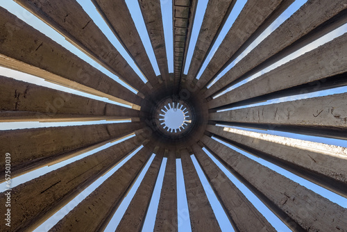 Abstract photo in a bottom view of a concrete monument with several pillars scattered in a circular pattern