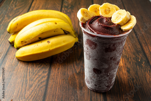 açaí and banana slices in a plastic cup photo