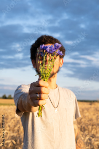 Man giving wild flowers