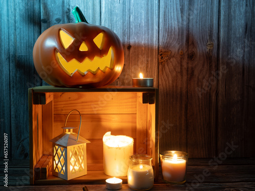 Halloween pumpkin head lantern on wooden background photo