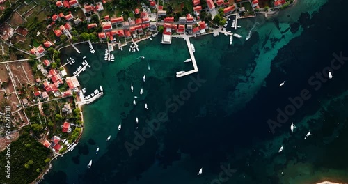 Drone top down bird's eye view of Ilovik island Croatia and coastline village homes photo