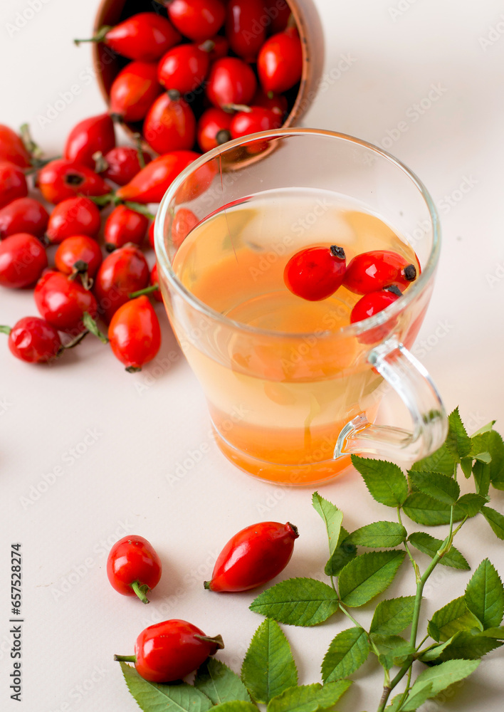 Cup with a drink made from rosehips, close-up, bowl with rosehips. Cup with a drink made from rosehips, close-up, bowl with rosehips.