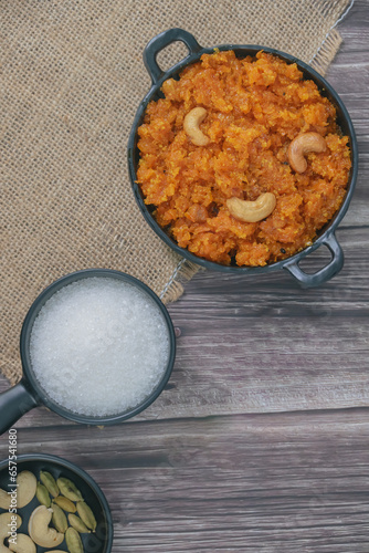 Gajar ka halwa is a carrot-based sweet dessert pudding from India. Garnished with Cashew/almond nuts.Gajar halwa, also known as gajorer halua, gajrela, gajar pak, and carrot halwa. photo