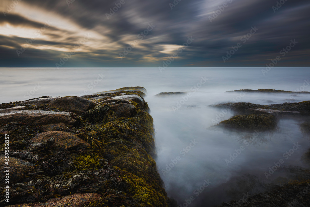 Sunset at a rocky shore in New England, long exposure shot