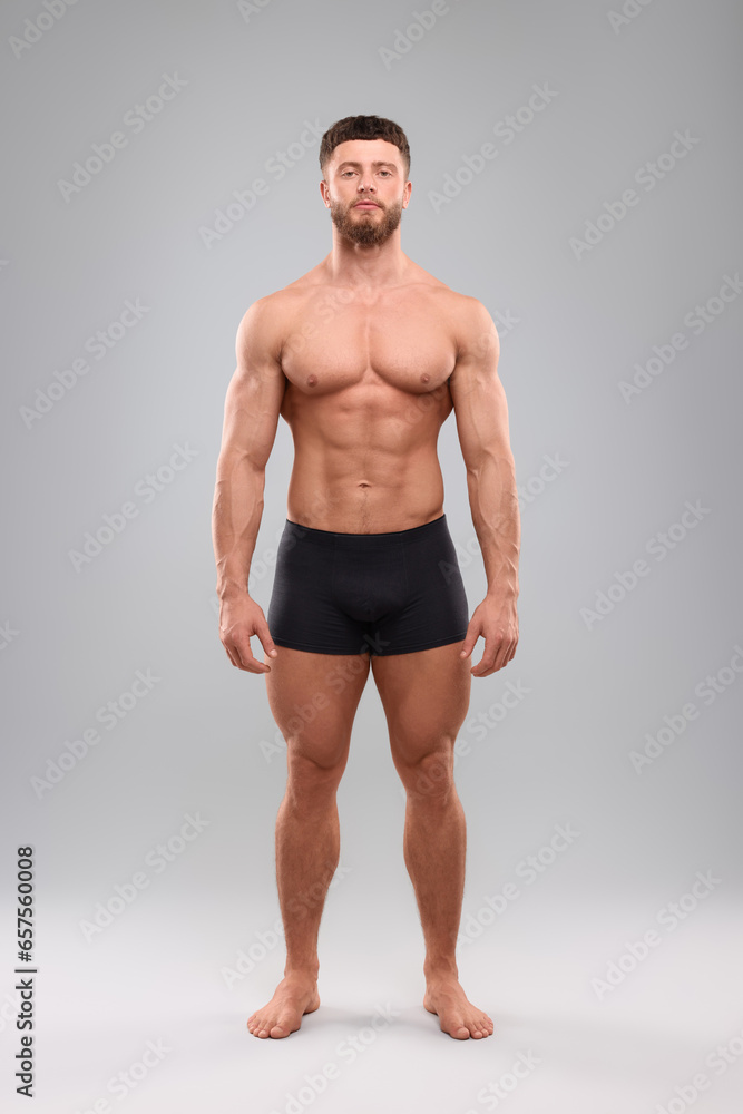 Handsome muscular man on light grey background. Sexy body Handsome muscular man on light grey background. Sexy body
