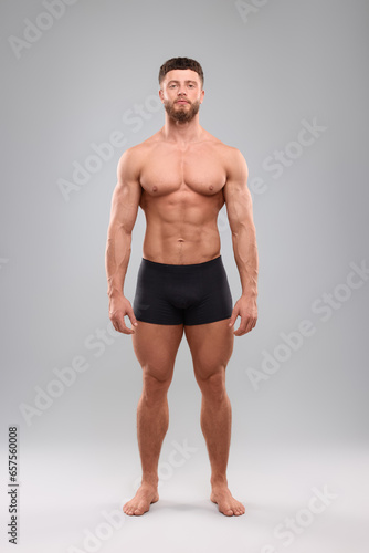 Handsome muscular man on light grey background. Sexy body