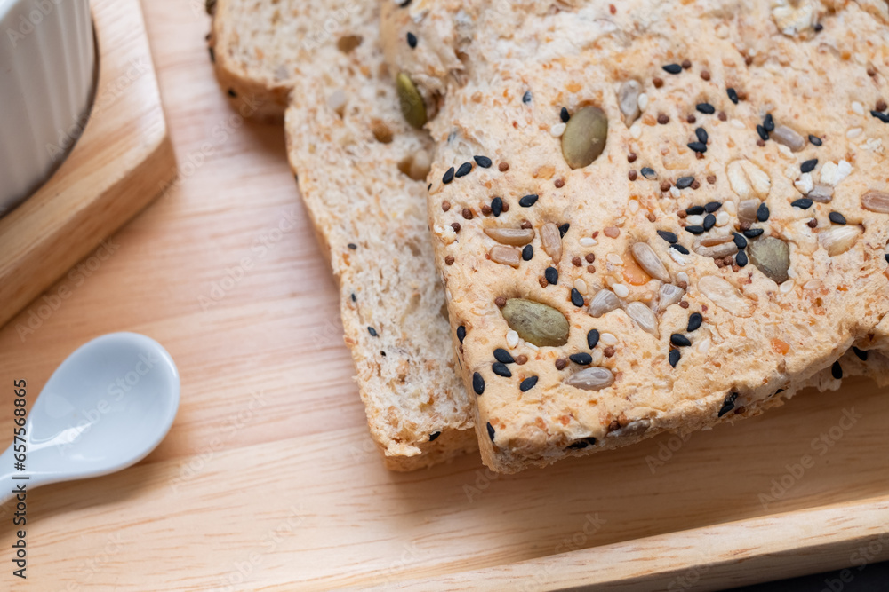 Closeup to homemade grain bread for breakfast on wooden tray Closeup to homemade grain bread for breakfast on wooden tray